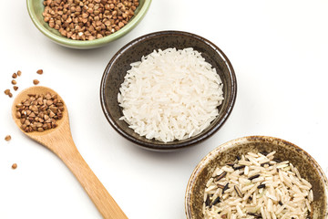 white rice, buckwheat and brown rice in plates