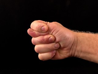 Hand gesture isolated on black background. The combination of three fingers. Hand shows thumb....