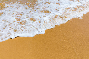Soft wave of blue ocean on sandy tropical beach. Background of tropical paradise beach with golden sand, travel tourism panorama background concept. Sand and sea waves background.