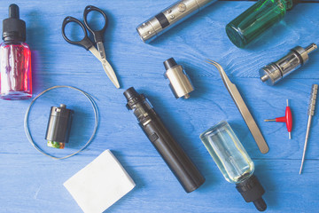vaping device mod and vaping staff on blue background