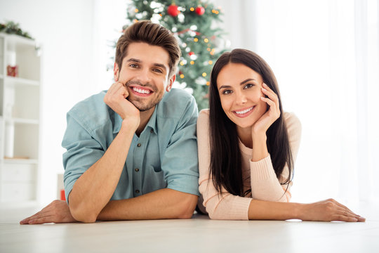 Close up photo of two people couple lying on floor enjoy christmas time x-mas holidays in house indoors