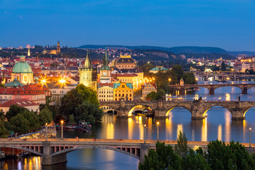 Obraz premium Scenic view of the Old Town pier architecture and Charles Bridge over Vltava river in Prague, Czech Republic. Prague iconic Charles Bridge (Karluv Most) and Old Town Bridge Tower at sunset, Czechia.