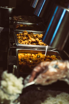 Array of popular dishes in stainless steel trays, like fried chicken, mechado or braised beef. Selective focus. Copy space.