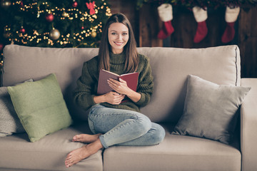 Full size photo of positive cheerful brown hair girl sit on divan hold book enjoy christmas...