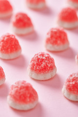 Closeup of a jelly candy on a pink background.