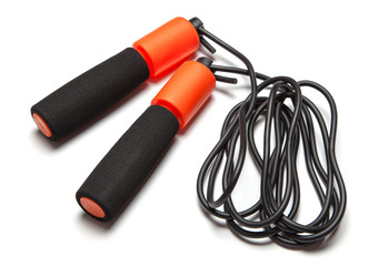 Jump rope. Fun exercises for body health. Orange rope with black cord. Isolated on white background
