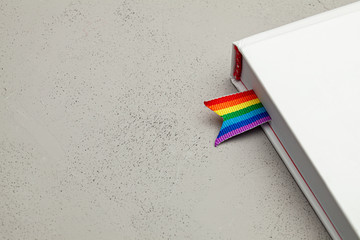 Book with bookmark and rainbow ribbon of LGBT pride - obrazy, fototapety, plakaty