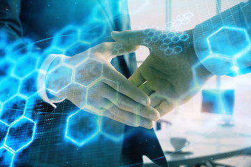 Multi exposure of tech theme hologram on office background with two men handshake. Concept of technology