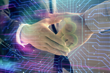 Multi exposure of bitcoin sign on abstract background with two men handshake. Concept of...