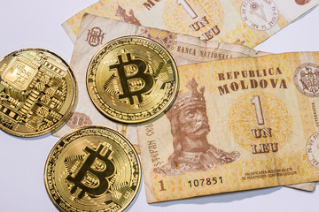 Close up of notes ofMoldovan leu (mdl) with bitcoins on white background.