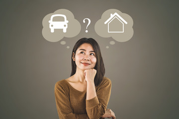 confused Asian woman buyer choosing between buying new home or car