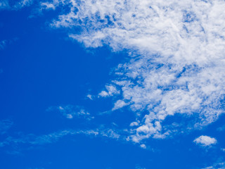 Fototapeta na wymiar Blue sky and wispy white clouds at a sunny day