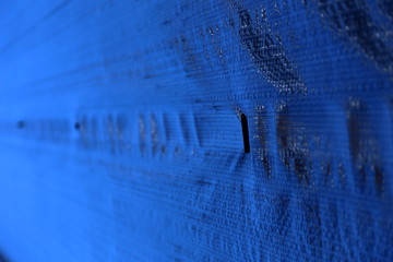 Construction work on old brick house with scaffolding, tarps, cement etc