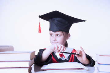 Child girl college graduate thinking about her perspectiv and future job. Humorous photo.