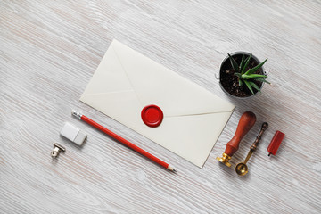 Blank vintage stationery set and retro envelope on light wooden background. Responsive design...