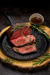 Sous-vide grilled beef with herbs in cast-iron skillet