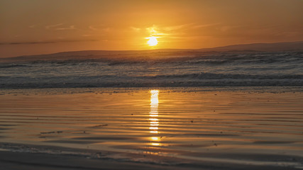Orange sunset over Enniscrone Beach, Ireland.