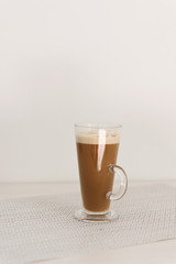 Long glass cup of cappuccino on coffe latte.