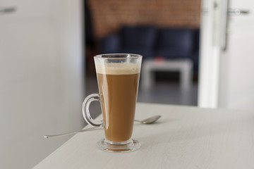 Long glass cup of cappuccino on coffe latte.