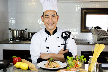 Asian Man Chef cooking food  in restuarant