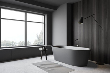 Grey and wood bathroom corner, tub and lamp