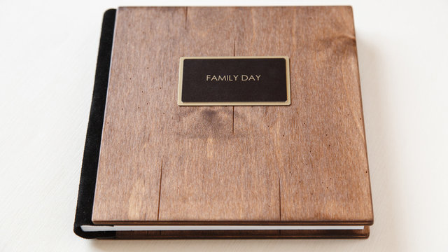 family album with wooden cover. Book or notebook with inscription "family day"