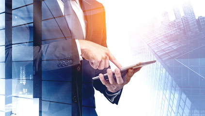 Successful businessman using tablet in city
