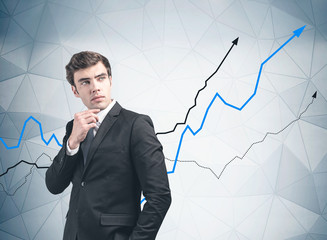 Thoughtful young manager, growing graph