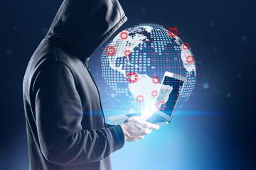 Young hacker using laptop for cyber crime