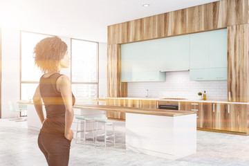 Beautiful African American woman in wooden kitchen