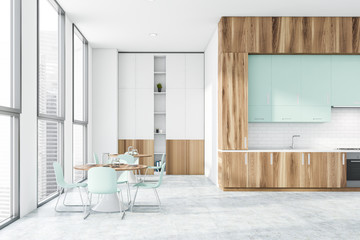 Wood and white kitchen with countertops and table