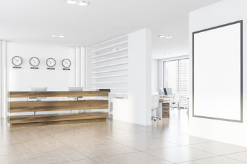 White office with clocks, reception and poster