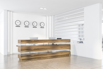 White office interior with clocks and reception