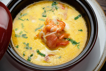 Fish soup in a pot with a red lid. catering menu