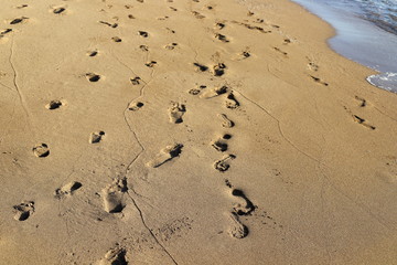 footprints in the sand on the shores of the Mediterranean Sea in the north of Israel