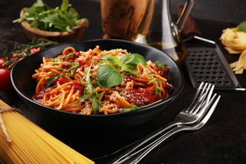 Plate of delicious spaghetti Bolognaise or Bolognese with savory minced beef and tomato sauce garnished with parmesan