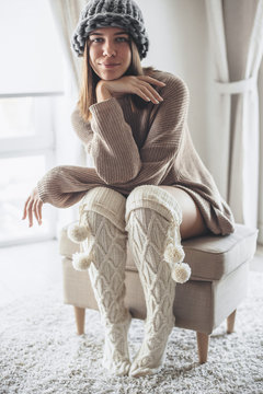 Cold lazy day in knitted socks and sweater at home