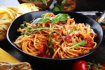Plate of delicious spaghetti Bolognaise or Bolognese with savory minced beef and tomato sauce garnished with parmesan