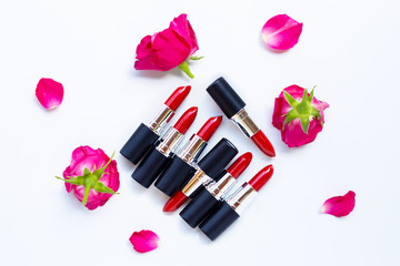 Obraz na płótnie Canvas Lipsticks with rose flower on white. Beautiful Make-up concept