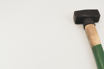 heavy sledge hammer on a blank surface