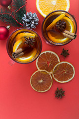Mulled wine and Christmas composition on the red background. Top view. Copy space. Location vertical.