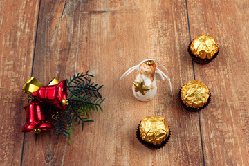 Top view Christmas decorations and ornaments on brown wooden background with copy space.
