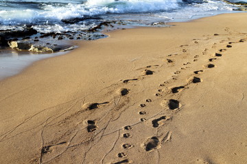 footprints in the sand on the shores of the Mediterranean Sea in the north of Israel