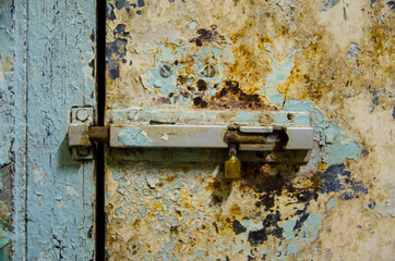 old latch is locking pale door in front view