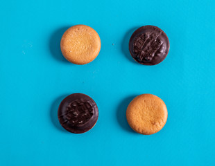 Chocolate and shortbread cookies on turquoise background.