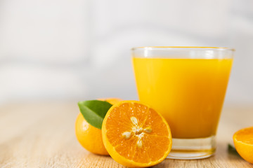 Orange juice on wooden table in the kitchen at home