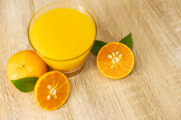 Orange juice on wooden table in the kitchen at home. Top view