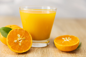 Orange juice on wooden table in the kitchen at home