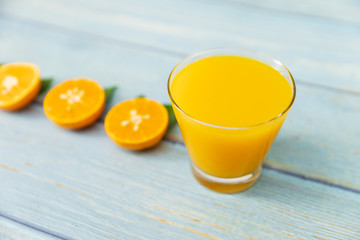 Orange juice on wooden table in the kitchen at home. Top view