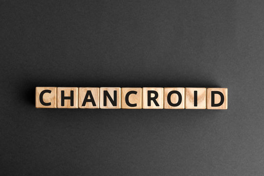 Chancroid - word from wooden blocks with letters, a venereal infection chancroid concept, grey background